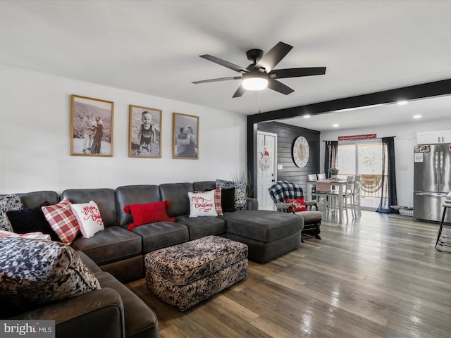 living room featuring hardwood / wood-style floors and ceiling fan