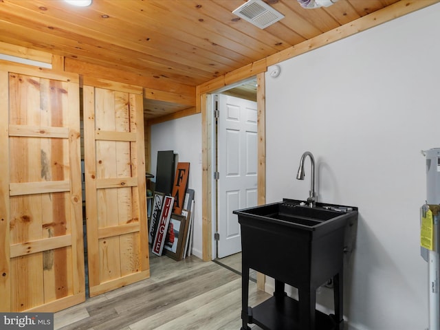 misc room with light hardwood / wood-style floors and wood ceiling