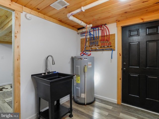 utility room featuring sink and water heater