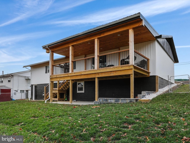 back of house featuring a patio, a deck, and a lawn