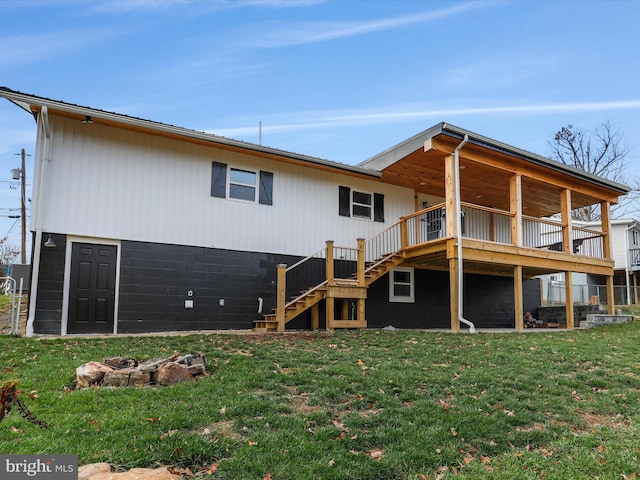 back of house with a lawn and a deck