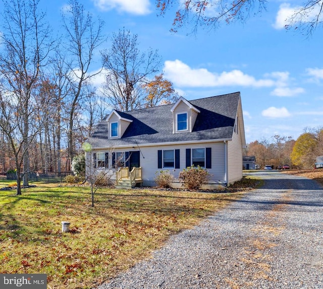 cape cod-style house featuring a front yard