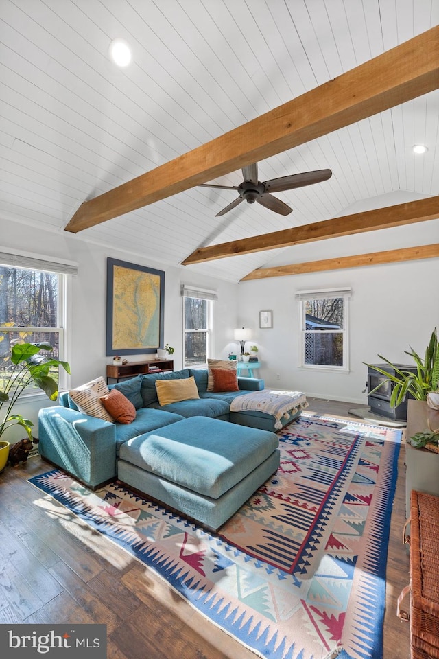 living room featuring wood-type flooring, vaulted ceiling with beams, plenty of natural light, and ceiling fan