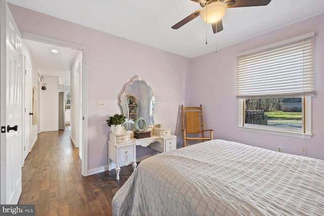 bedroom with ceiling fan and dark wood-type flooring