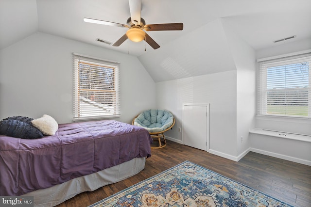 bedroom featuring dark hardwood / wood-style floors, vaulted ceiling, and ceiling fan