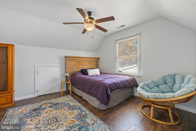 bedroom with ceiling fan, dark wood-type flooring, and lofted ceiling