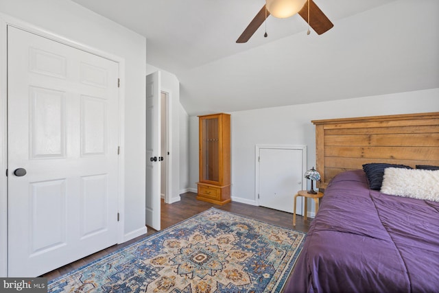 bedroom featuring ceiling fan, dark hardwood / wood-style flooring, and lofted ceiling