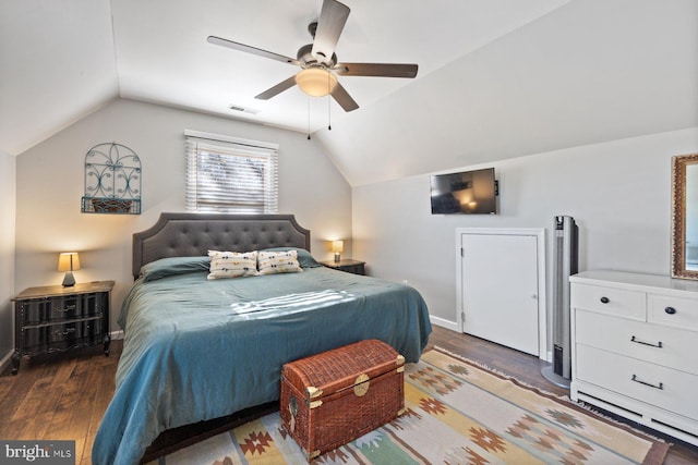 bedroom with dark hardwood / wood-style flooring, ceiling fan, and lofted ceiling