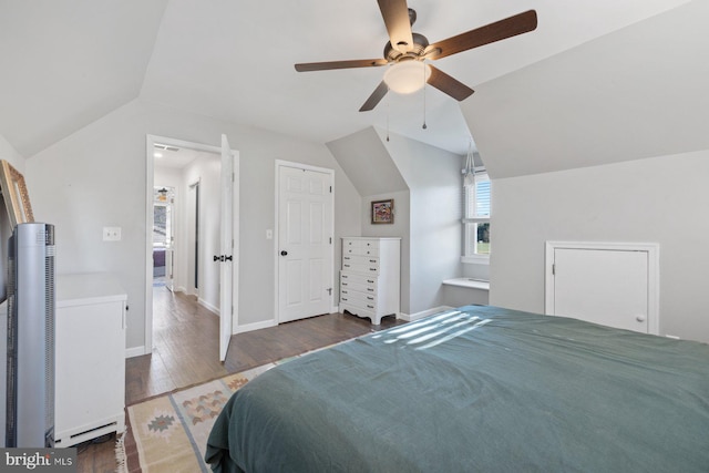 bedroom with ceiling fan, dark hardwood / wood-style floors, and vaulted ceiling