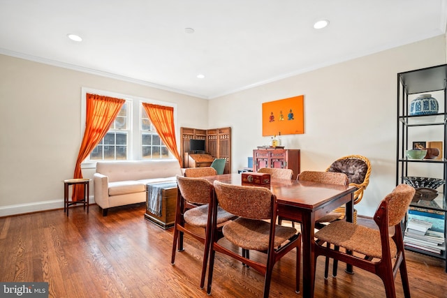 dining space with crown molding and dark wood-type flooring