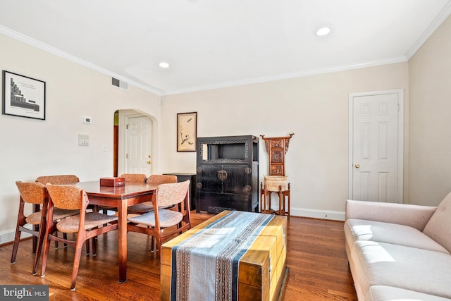 dining area featuring dark hardwood / wood-style flooring and ornamental molding