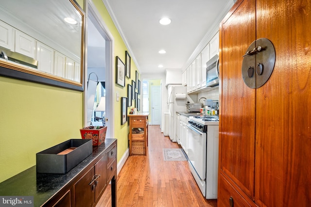 kitchen featuring white cabinetry, white appliances, and ornamental molding