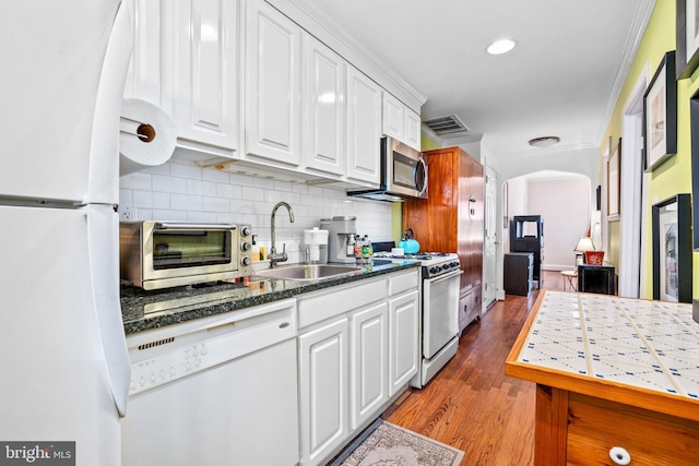 kitchen with white appliances, crown molding, sink, light hardwood / wood-style flooring, and white cabinets