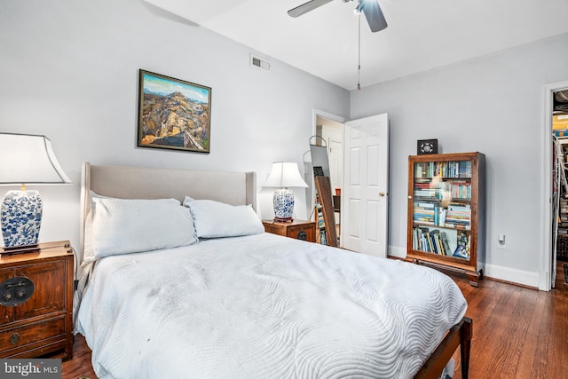 bedroom with ceiling fan and dark hardwood / wood-style floors