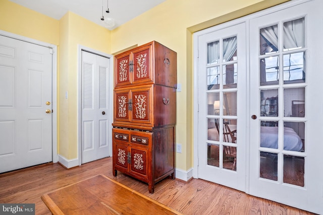 entryway with french doors and hardwood / wood-style flooring