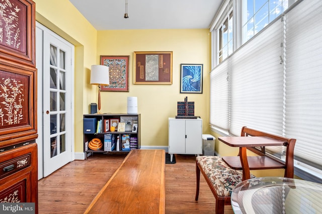 sitting room featuring french doors and light hardwood / wood-style flooring