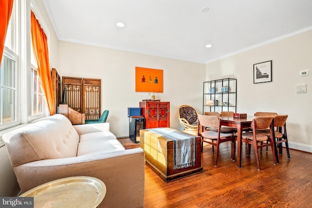 living room featuring hardwood / wood-style flooring and ornamental molding