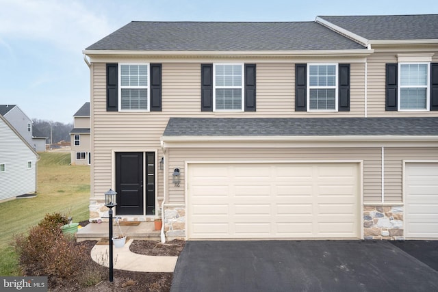 view of front of house featuring a garage and a front lawn