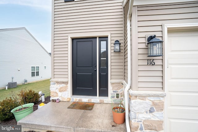 doorway to property with central AC