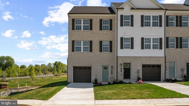 view of front of property with a garage and a front yard