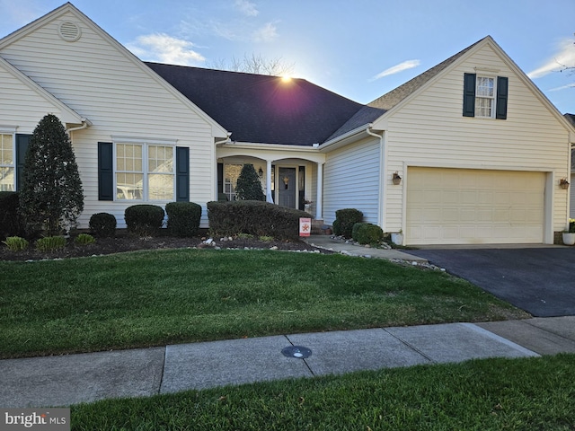 view of front facade with a garage and a front yard