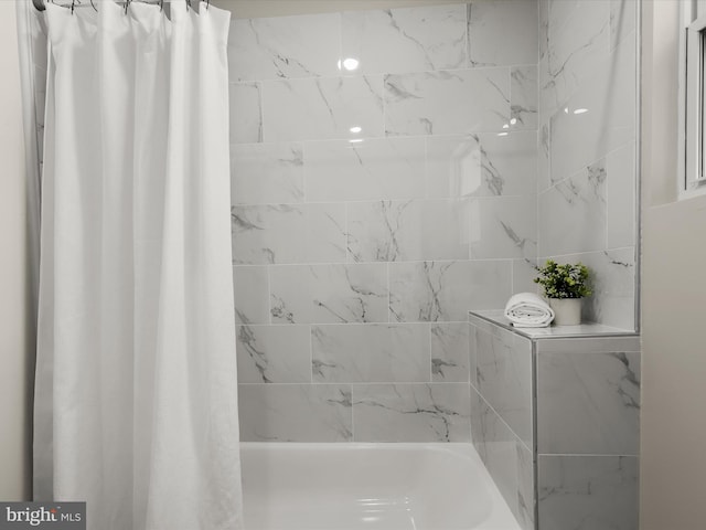 bathroom with shower / bath combination with curtain