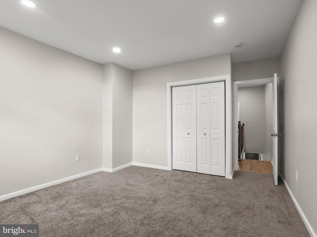 unfurnished bedroom featuring carpet floors and a closet