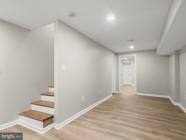 hallway with light hardwood / wood-style floors