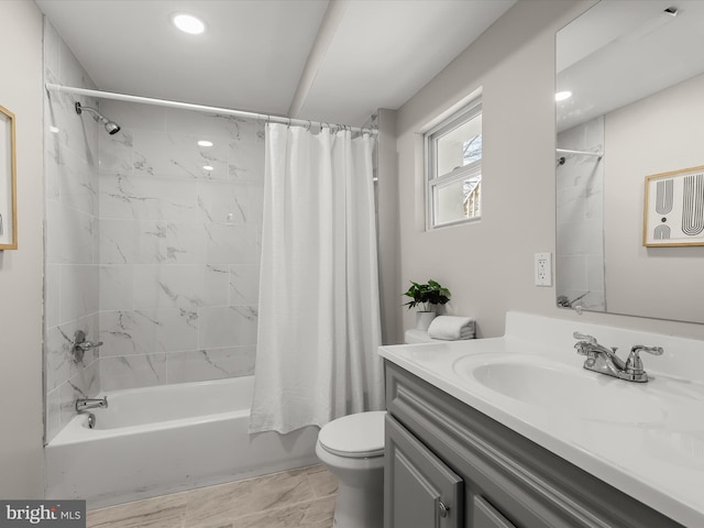 full bathroom featuring toilet, vanity, and shower / bathtub combination with curtain