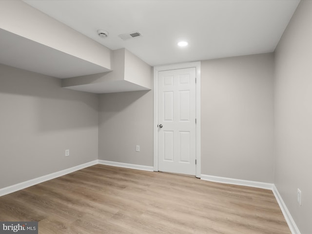 basement with light hardwood / wood-style floors