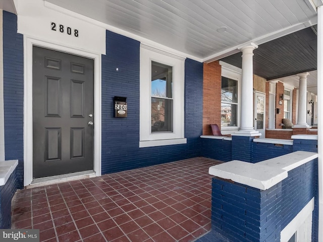 view of exterior entry featuring a porch