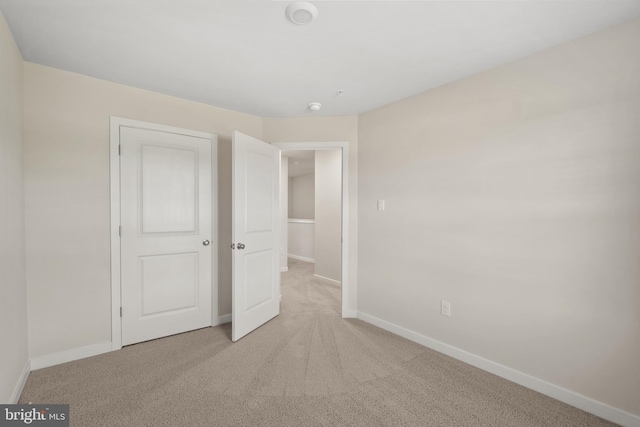 unfurnished bedroom featuring light carpet