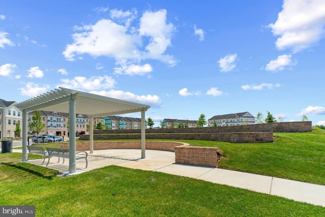 view of community featuring a pergola and a lawn