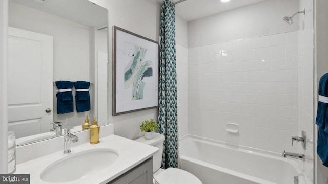 full bathroom featuring vanity, shower / tub combo, and toilet