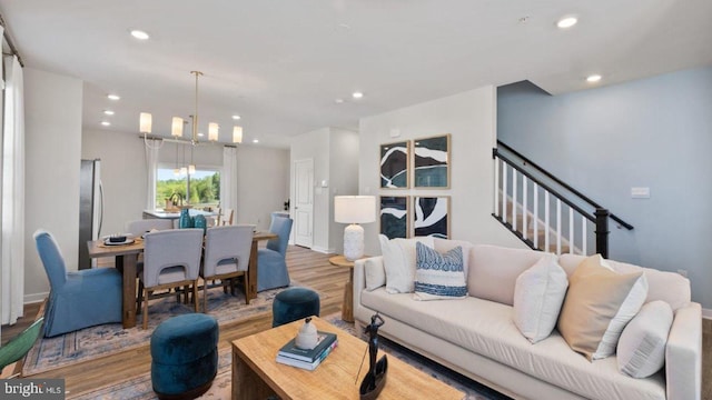 living room featuring hardwood / wood-style floors and a chandelier