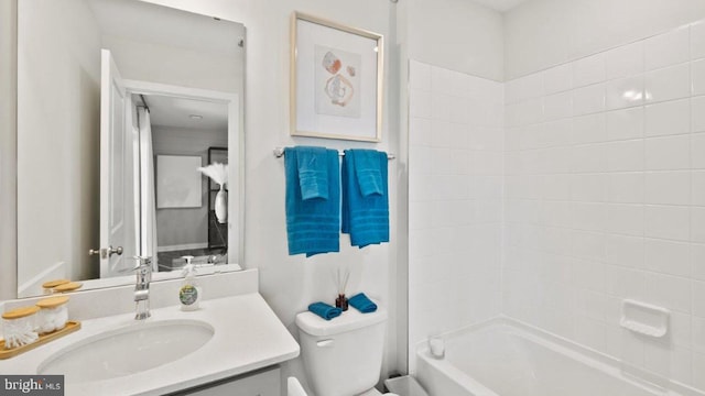 full bathroom featuring washtub / shower combination, vanity, and toilet