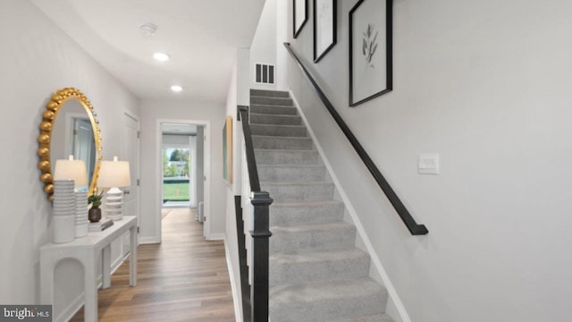 stairway featuring wood-type flooring