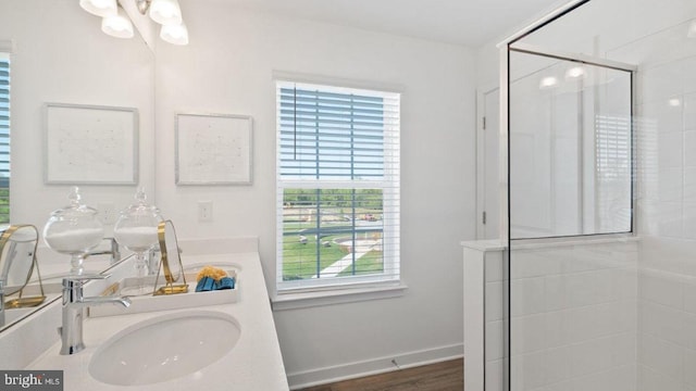 bathroom with vanity, a healthy amount of sunlight, an enclosed shower, and hardwood / wood-style flooring