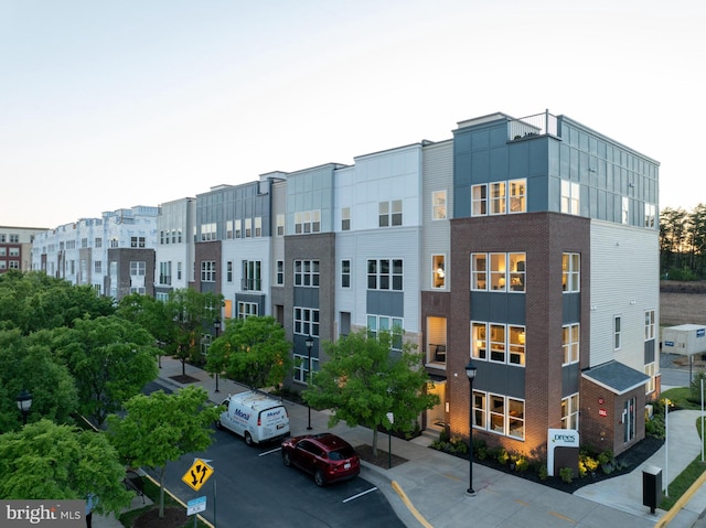 view of building exterior featuring uncovered parking