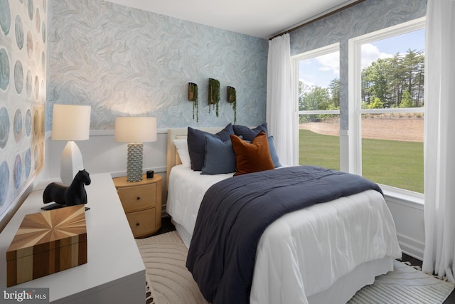 bedroom with wallpapered walls and multiple windows