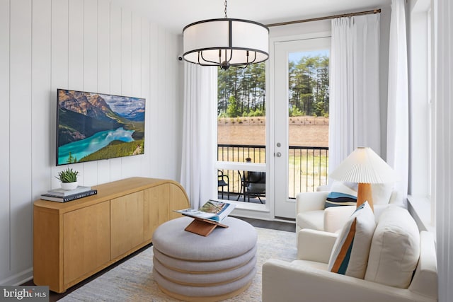 living area featuring wood finished floors and wood walls