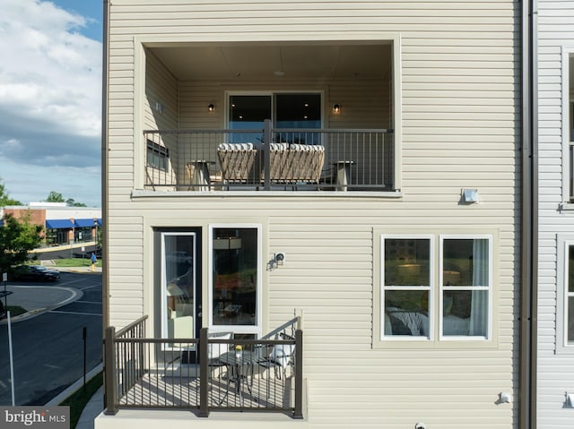 back of property with a balcony
