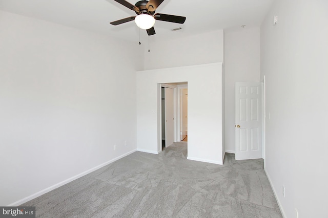 unfurnished bedroom featuring ceiling fan and light carpet