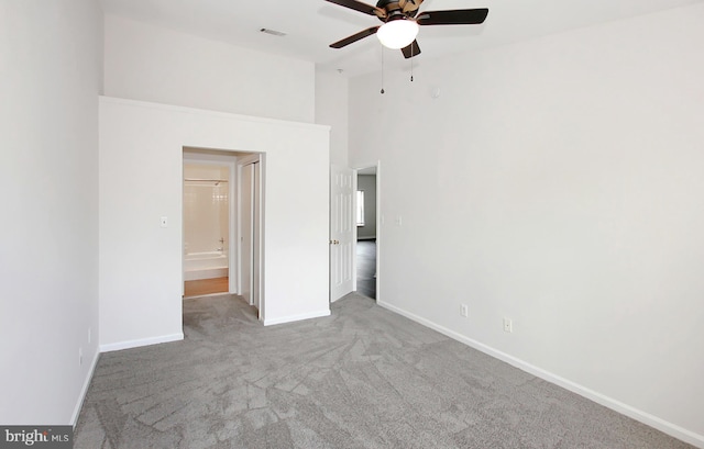 unfurnished bedroom featuring light colored carpet and ceiling fan