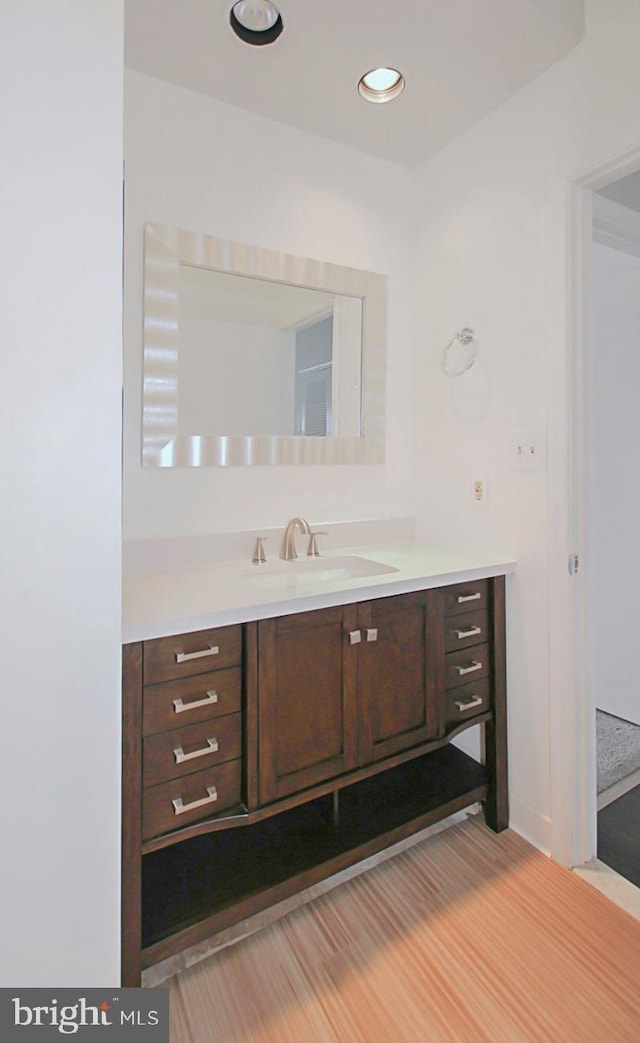 bathroom with hardwood / wood-style flooring and vanity