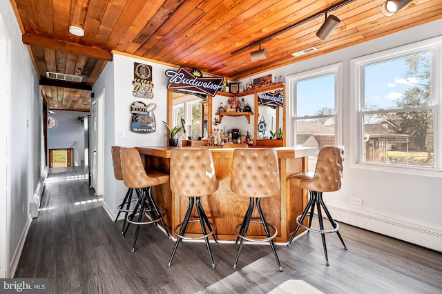 bar featuring hardwood / wood-style flooring, a baseboard radiator, and wood ceiling