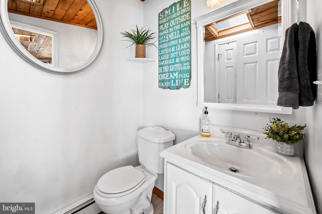 bathroom featuring vanity, a skylight, toilet, and wood ceiling