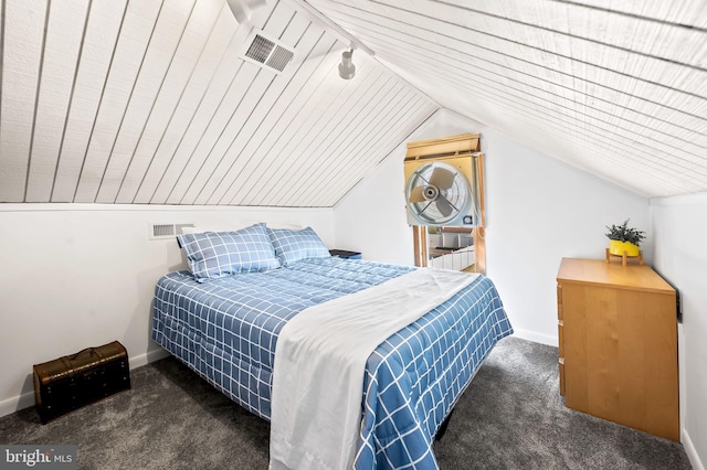 bedroom featuring vaulted ceiling and dark colored carpet