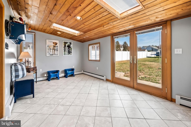 interior space with french doors, a baseboard radiator, vaulted ceiling with skylight, light tile patterned flooring, and wood ceiling