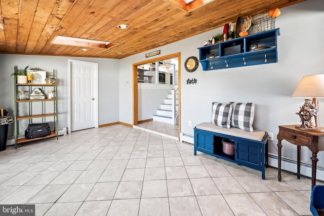 entrance foyer featuring a baseboard heating unit, light tile patterned floors, and wooden ceiling